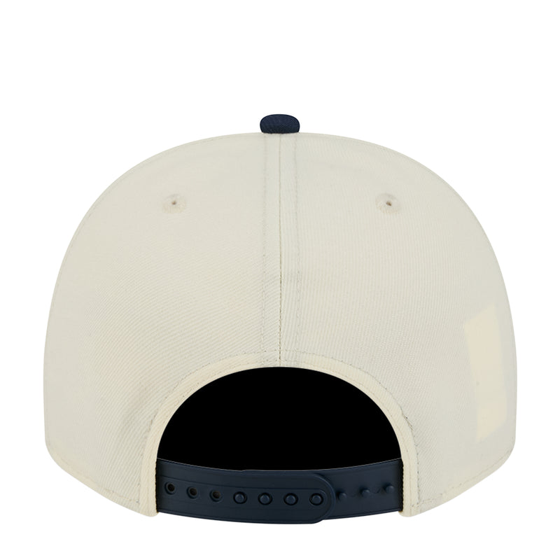 Cream baseball cap back view with adjustable strap and breathable eyelets.