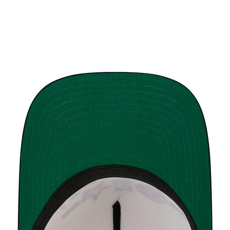 Green baseball cap top with black-trimmed inner panel and stitched pattern.