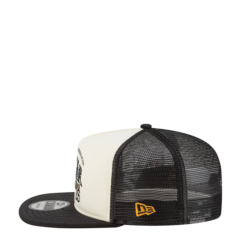 Two-tone A-frame trucker cap with white panels and black mesh side, embroidered badge