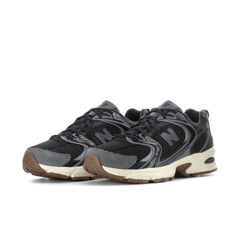 Black mesh athletic sneakers with gray overlays, N logo, beige midsole, gum outsole