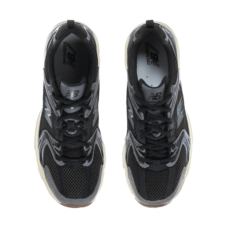 Black sneakers viewed from toe, mesh lining, cushioned collar, lace-up design