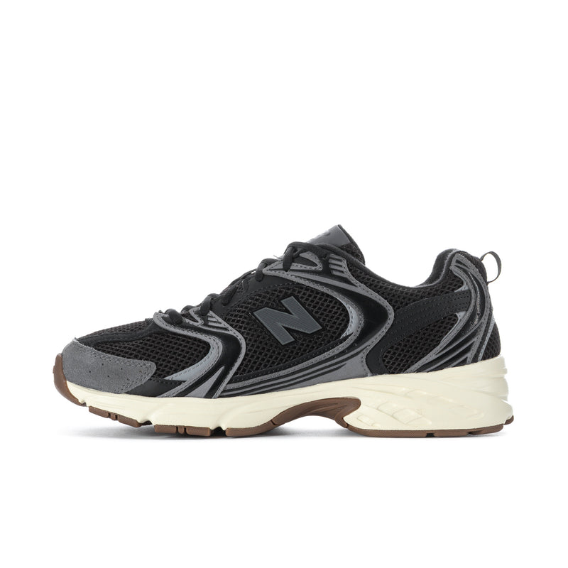 Black mesh sneakers with gray overlays, large N logo, light beige midsole, gum accents