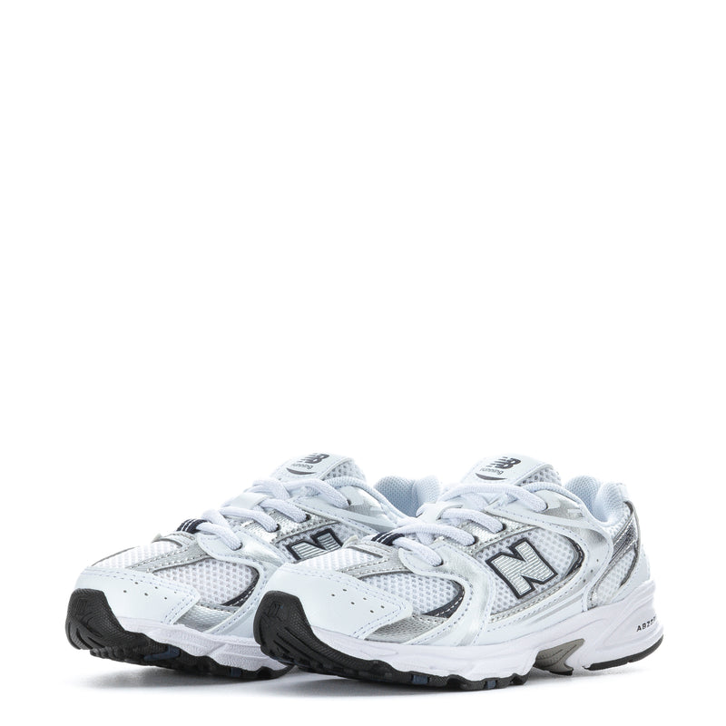 Toddler white and navy New Balance sneakers with lace-up closure and rear branding