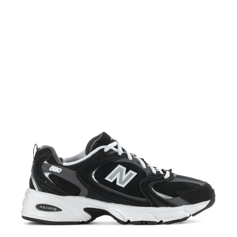 Wide women’s athletic sneakers in black with white sole and large N logo