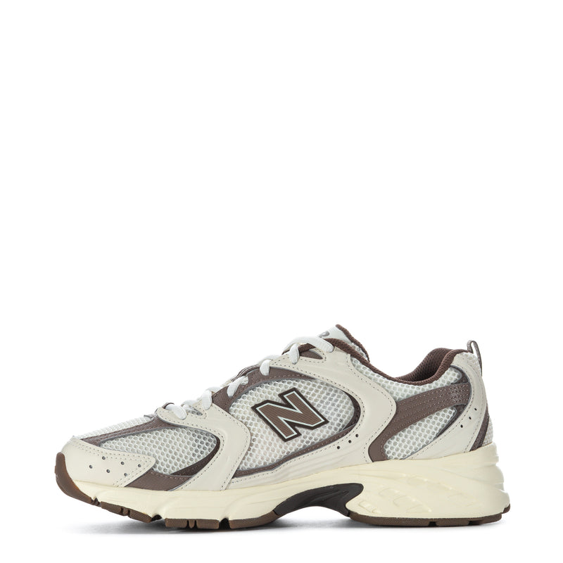 Lace-up running shoe with cream suede panels, gray mesh overlays, brown detail