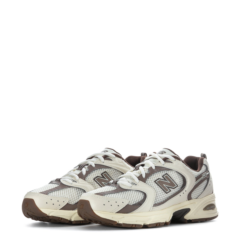 Pair of lace-up sneakers with N logo, cream uppers, gray mesh, brown outsole