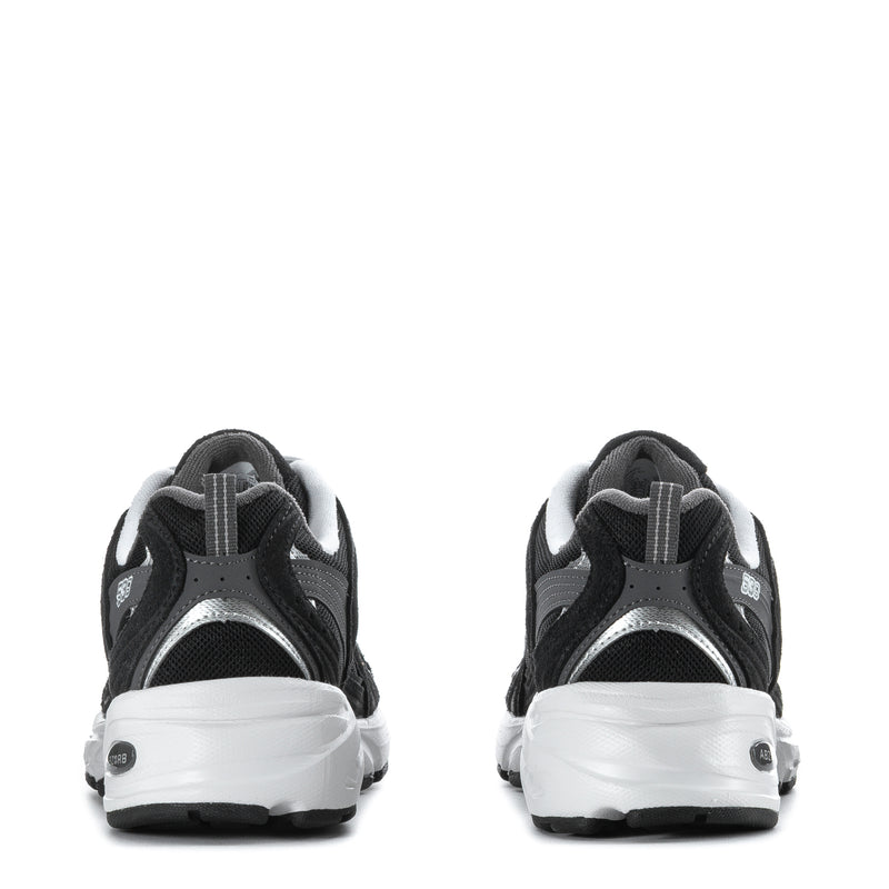 Wide women’s athletic sneakers, back view in black with white heel panel and laces