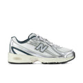 Men's athletic shoes in white metallic with teal accents, N logo and lace-up design