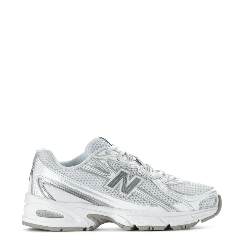 Women's white lace-up running sneakers with metallic silver accents and cushioned sole