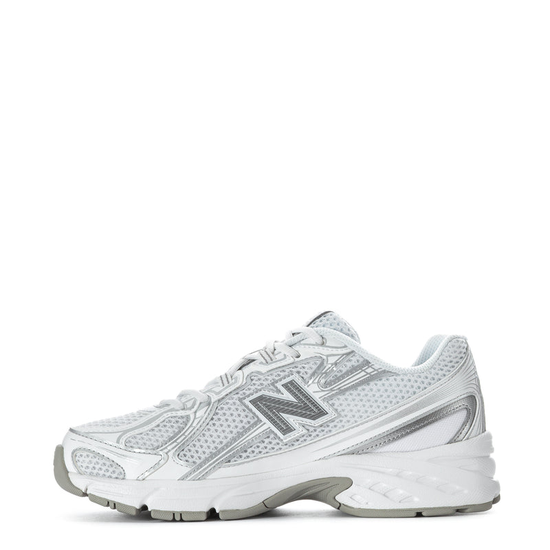 Women's white lace-up sneakers with metallic silver logo and thick midsole