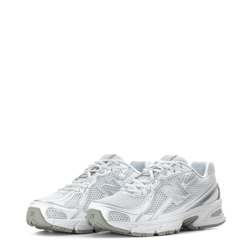 Pair of white lace-up sneakers with metallic silver logo, mesh upper, cushioned soles