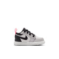 Kids low-top sneakers in white and black with black laces and red accents