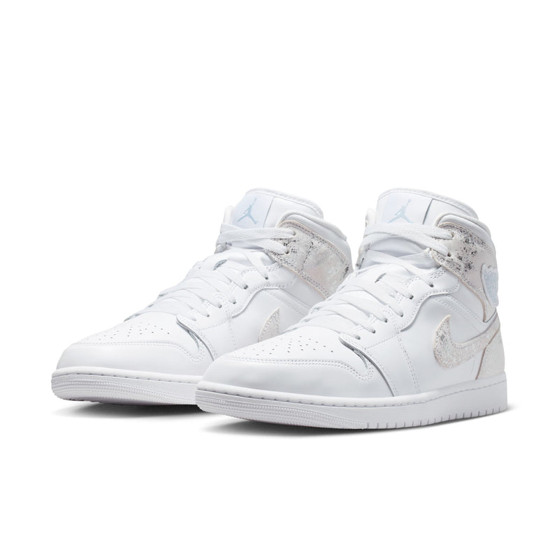 Pair of men's mid-top sneakers, white leather with speckled overlays and blue accents