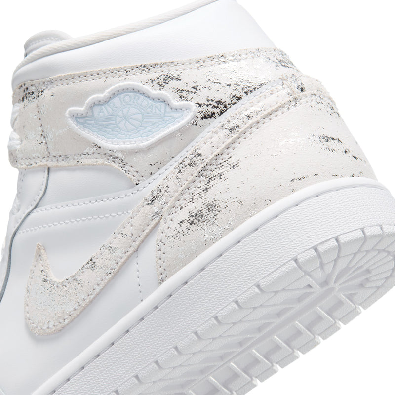 Close-up of men's mid-top sneaker side with speckled fabric and light blue heel badge
