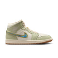 Women’s mid-top sneaker in light olive and white with blue Nike swoosh, lace-up