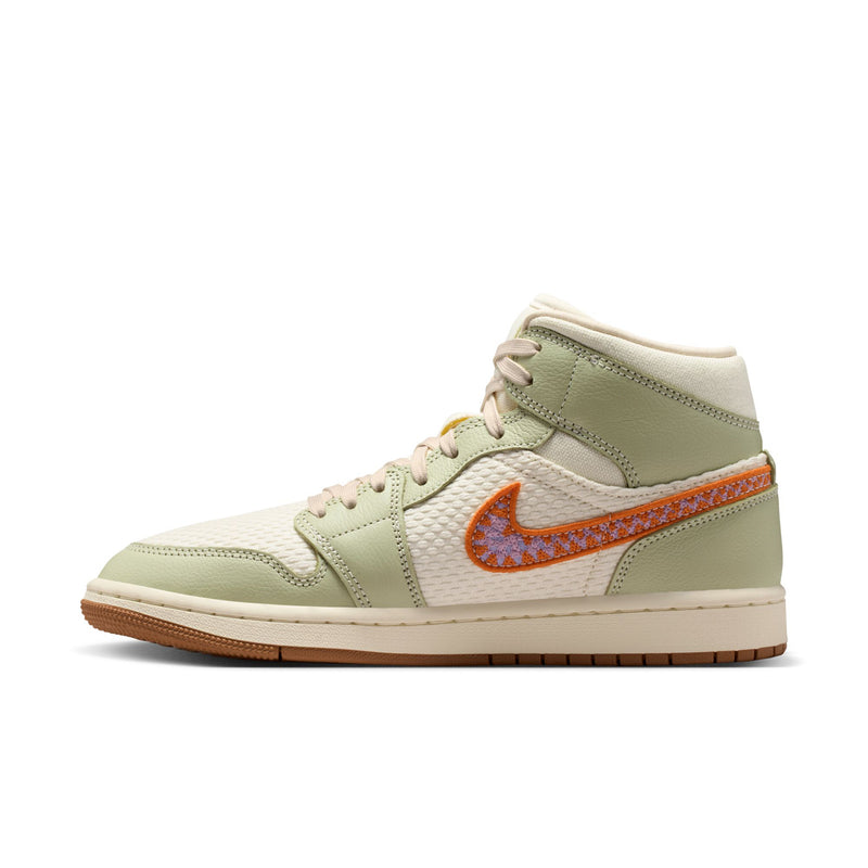 Women’s mid-top sneaker with light olive upper, orange accent swoosh, and lace-up