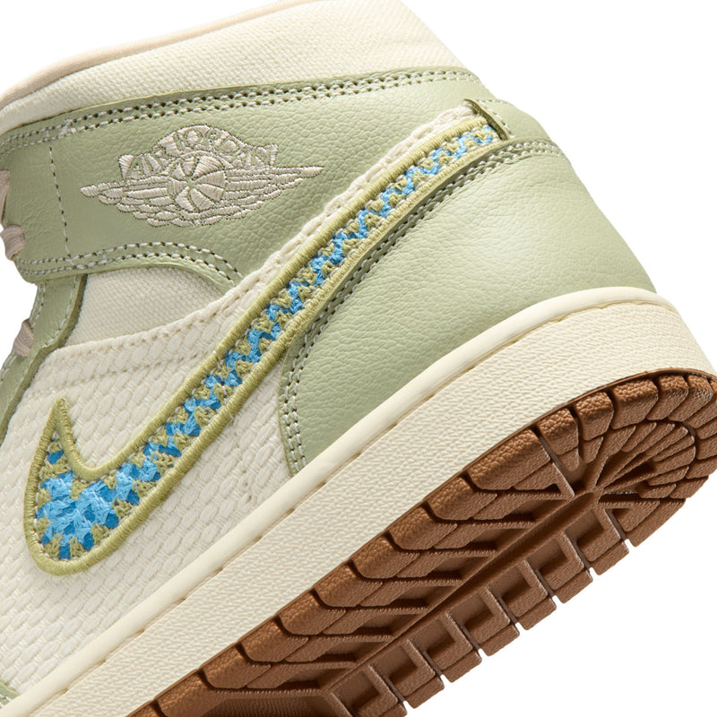 Close-up side view: olive wing logo, blue stitching swoosh, and white midsole