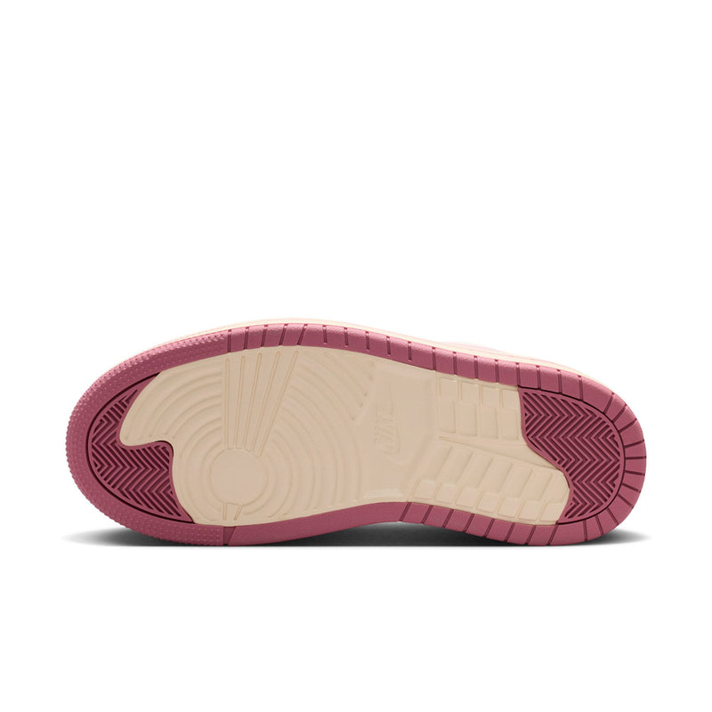 Bottom view of pale ivory sneakers with pink rubber outsole and textured tread