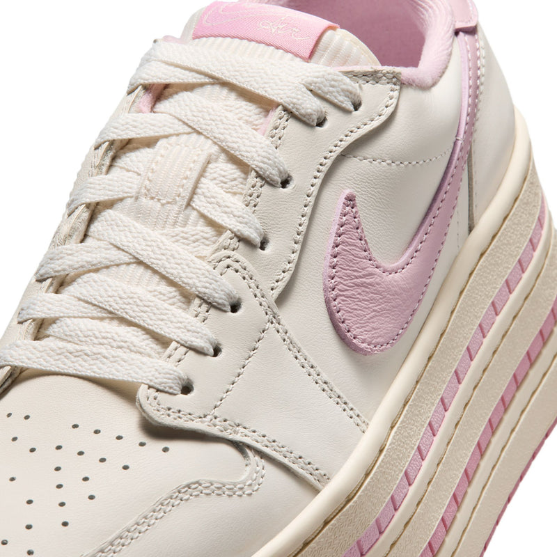 Close-up of pale ivory sneaker upper with white laces and pink swoosh