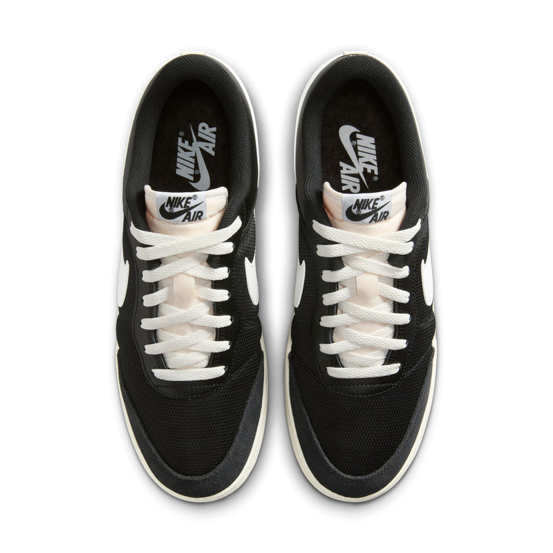 Men's black low-top sneakers with white laces and Nike Air branding, gum sole