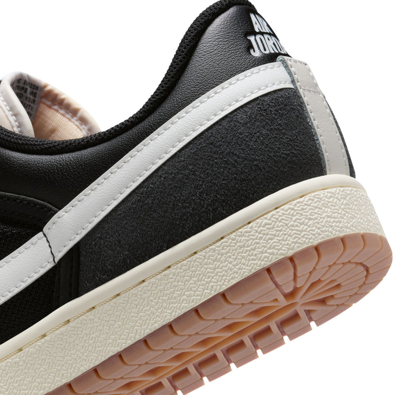 Men's black-and-white sneakers with leather heel strap and textured gum sole