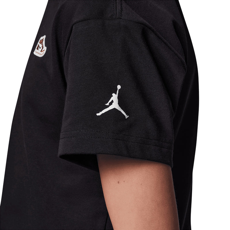 Black youth t-shirt sleeve with Jumpman silhouette graphic near hem