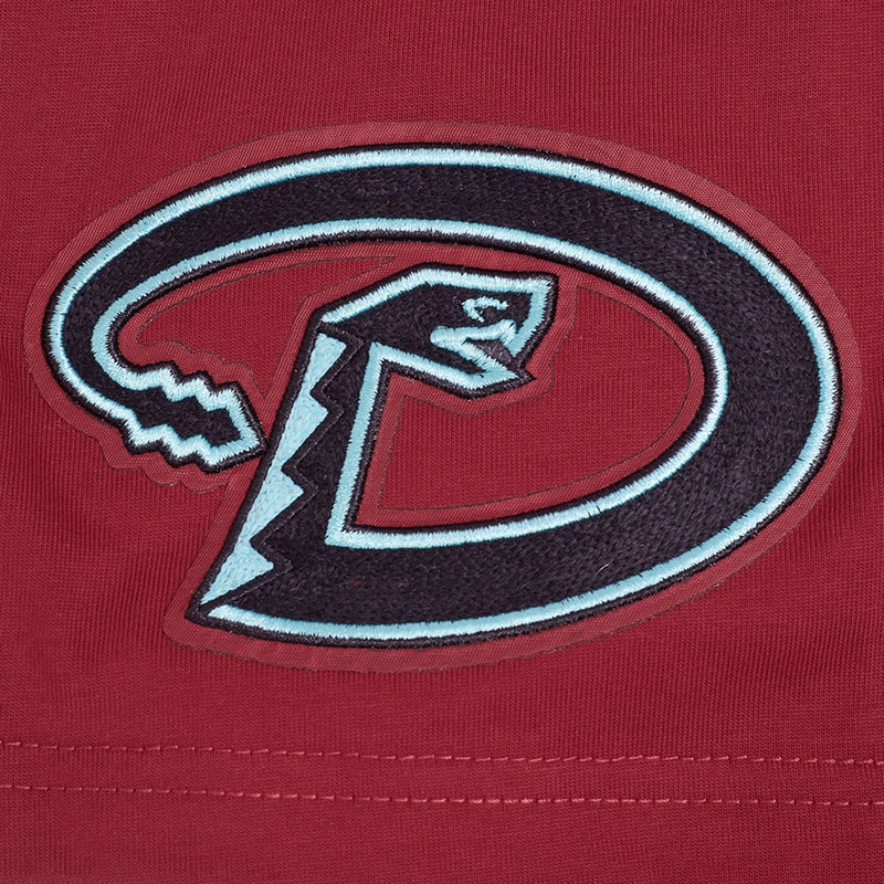 Close-up of Arizona Diamondbacks oval D logo on men's red T-shirt sleeve