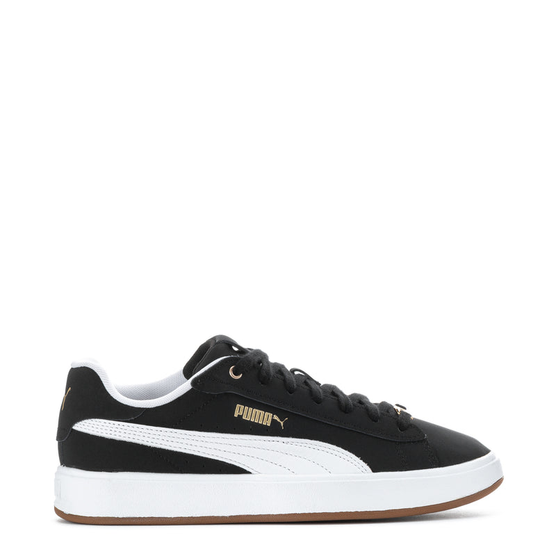 Women's black Puma sneakers with white side stripe, gum sole, and round laces