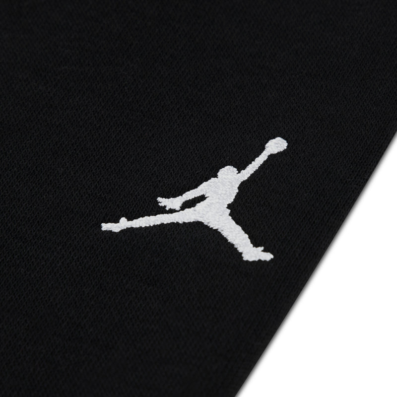 Black jogger leg with white Jordan Jumpman logo, knit fleece fabric