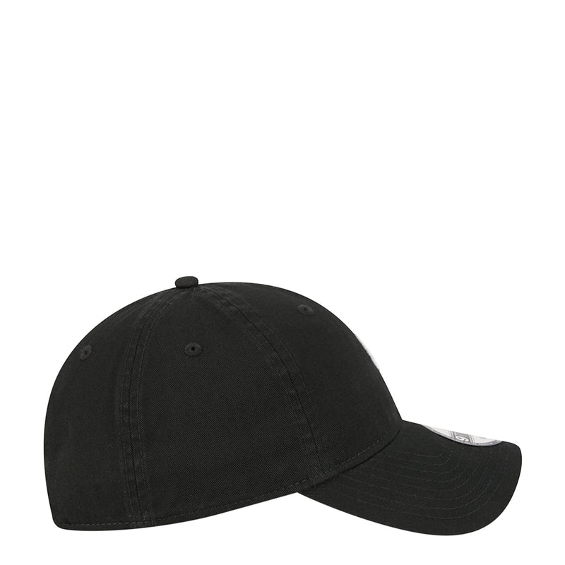Black baseball cap, side view with curved brim and New Era logo detail