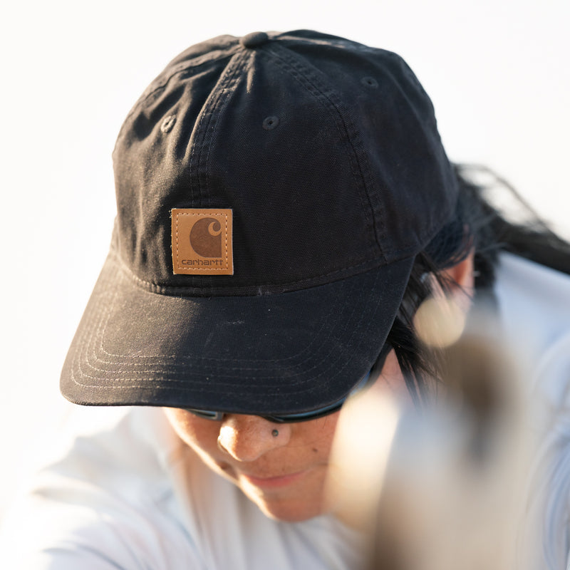 Black canvas dad cap with Carhartt logo patch, worn front view