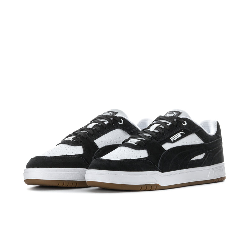 Low-top sneakers in black and white with lace-up closure and gum outsole.