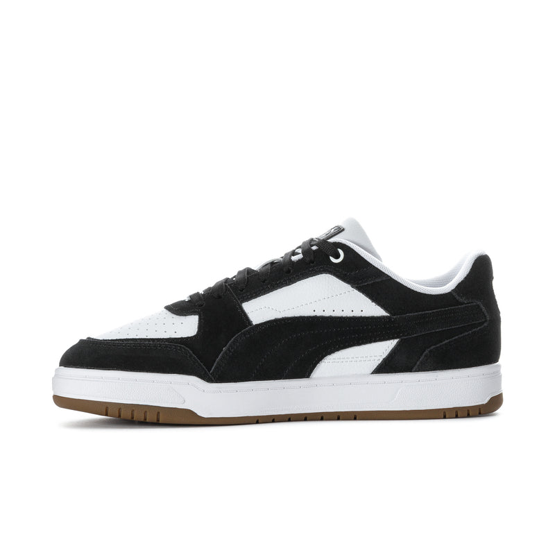 Side view of black and white lace-up sneakers with suede overlays.