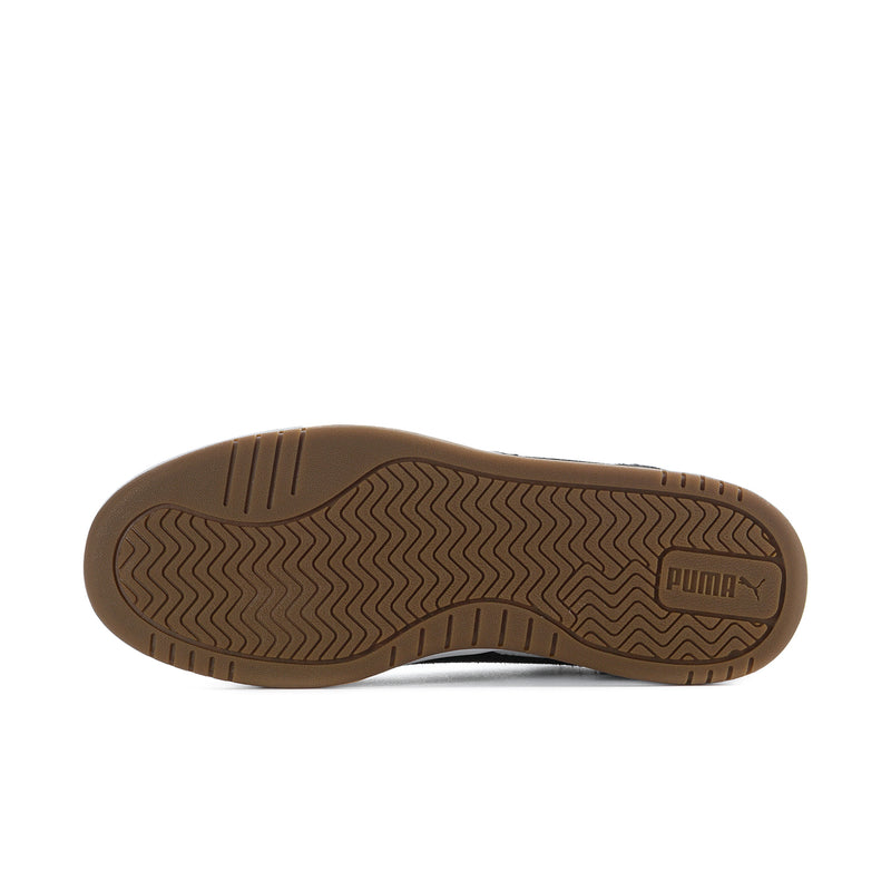 Outsole view of low-top sneakers with textured rubber tread and Puma mark.