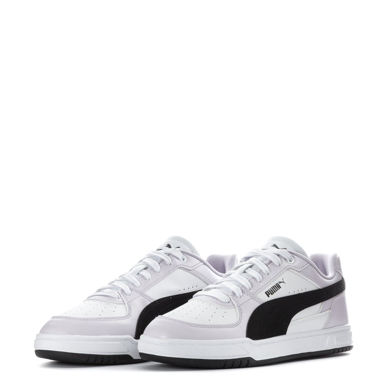 Youth white Puma sneakers, front view with perforated toe and black side stripe