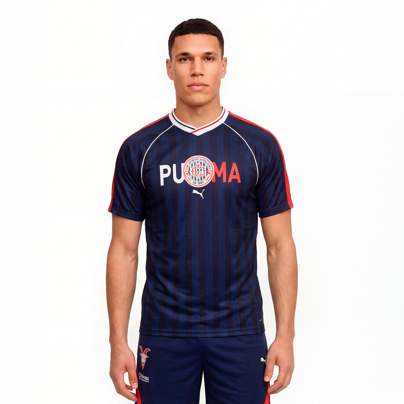 Men's navy soccer jersey on model, V-neck with red and white collar trim