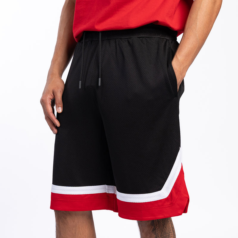 Black basketball shorts with red-and-white hem band, mesh finish, drawstring front