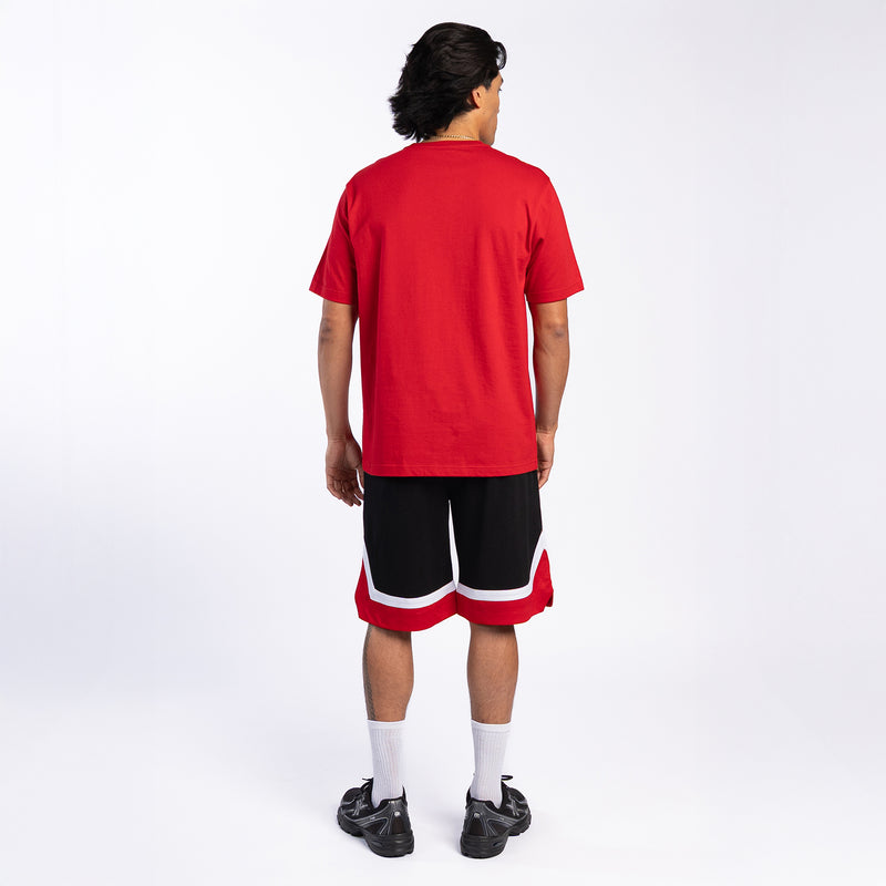 Men's black basketball shorts with red-and-white hem stripe, back view
