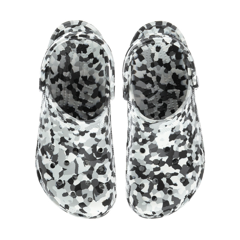 Pair of men's clogs in black-and-white confetti animal print, side view.