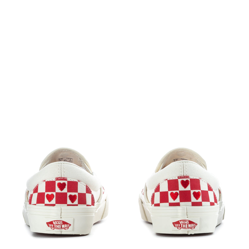 Heels of red checkered slip-on sneakers with heart pattern and Vans patch