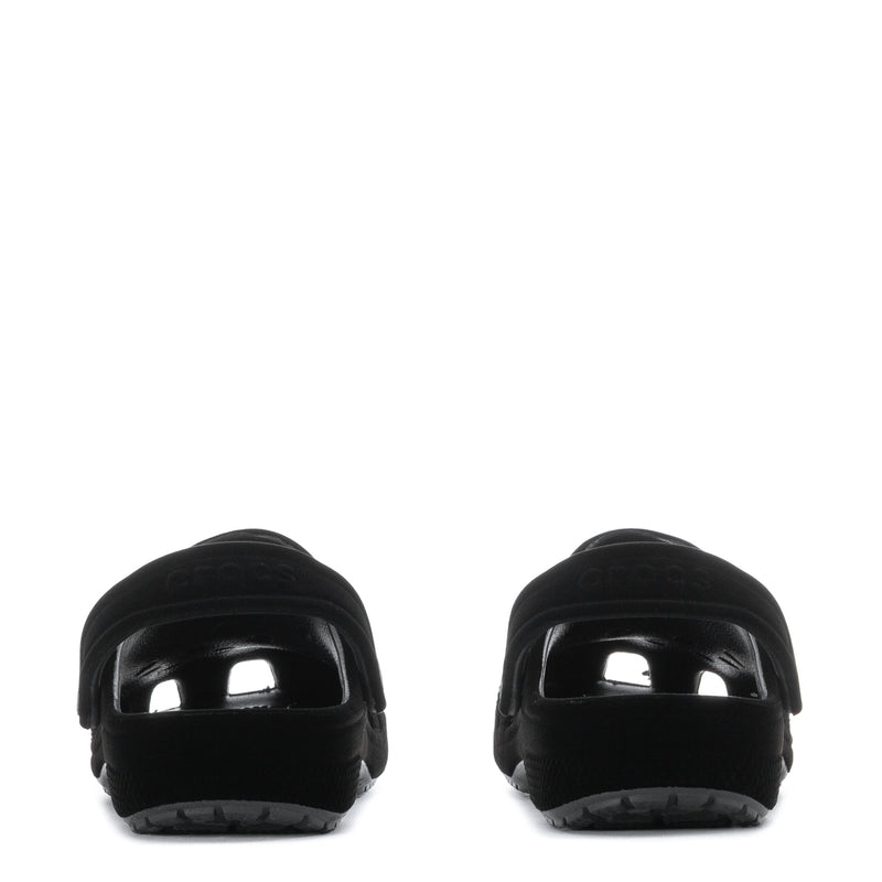 Youth black clogs heel view with glossy toe caps and textured sole