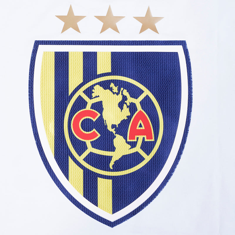 Men's white tee close-up of blue shield crest with three gold stars above