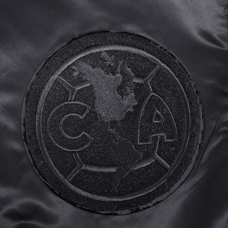 Black embroidered round crest patch with globe and eagle detail.