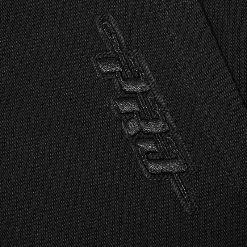 Close-up of black embroidered vertical logo detail