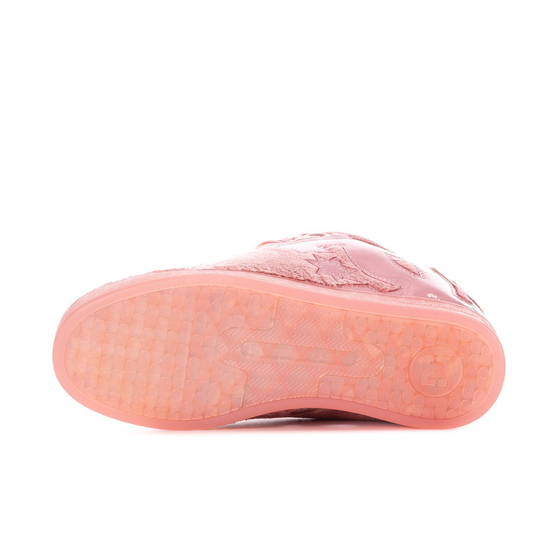 Pink low-top sneaker outsole view with textured sole and sidewall logo.