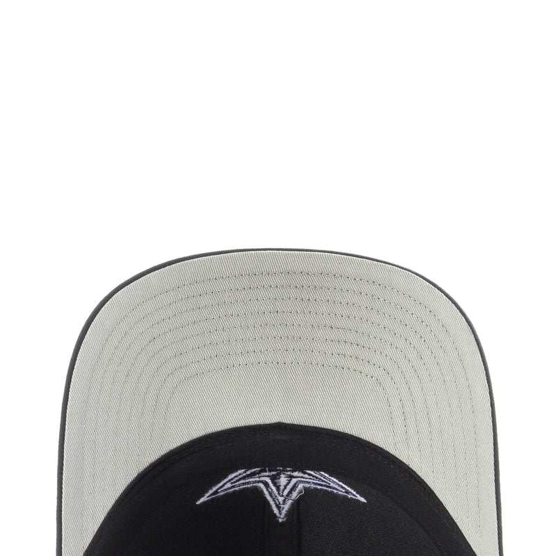 Light gray and black trucker hat brim close-up with stitched panels