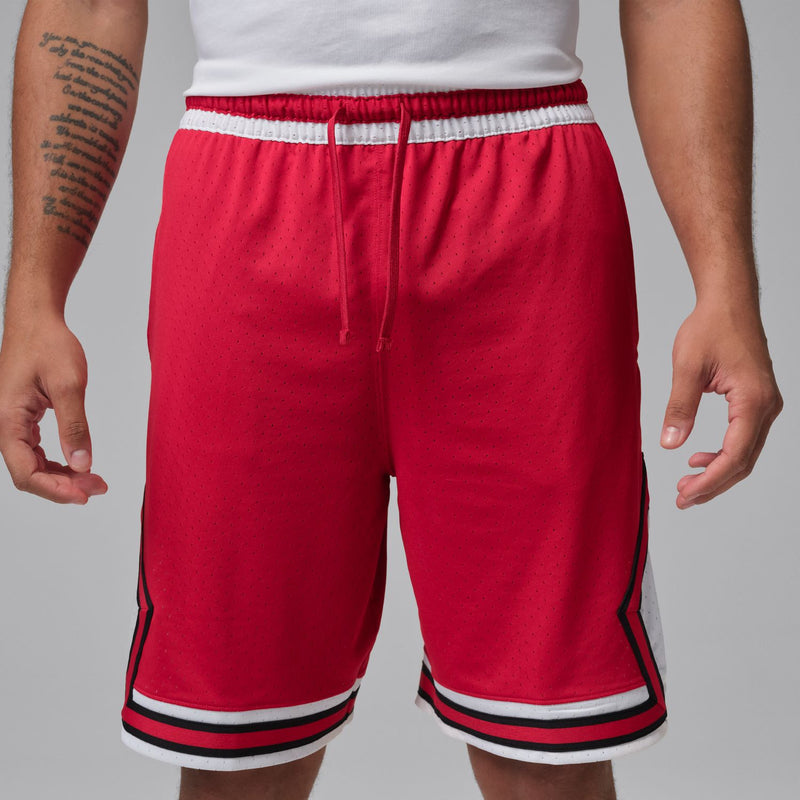Red men’s basketball shorts with elastic waistband, drawstring, and striped hem
