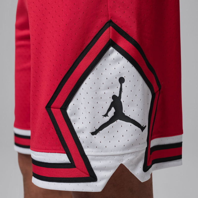 Red shorts with diamond-shaped emblem patch and white-and-black striped hem