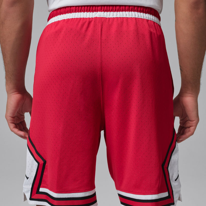 Red men’s basketball shorts with elastic waistband and striped side panels