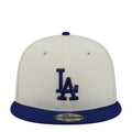 Two-tone baseball cap with cream crown and royal blue brim, featuring LA logo.